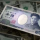 Yen slides, dollar gains as Bank of Japan is expected to maintain loose policy